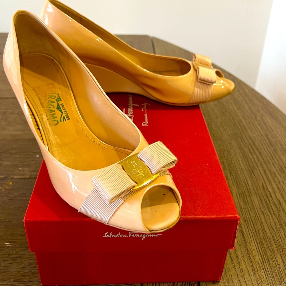Salvatore Ferragamo Leather Wedge Pumps
Peep-Toes with Bow Accents
